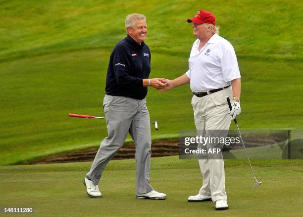 Tycoon Donald Trump plays a round of golf with Scottish golfer Colin Montgomerie as he officially opens his new multi-million pound Trump...