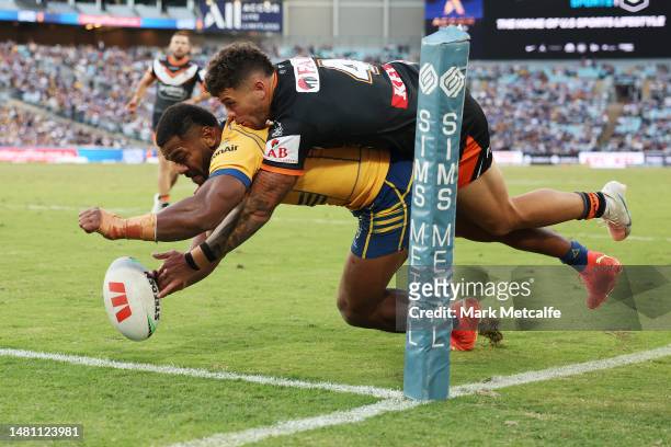 Maika Sivo of the Eels scores a try as he is tackled by Staford To'a of the Wests Tigers during the round six NRL match between Wests Tigers and...