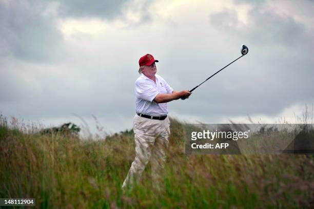 Tycoon Donald Trump plays a stroke as he officially opens his new multi-million pound Trump International Golf Links course in Aberdeenshire,...