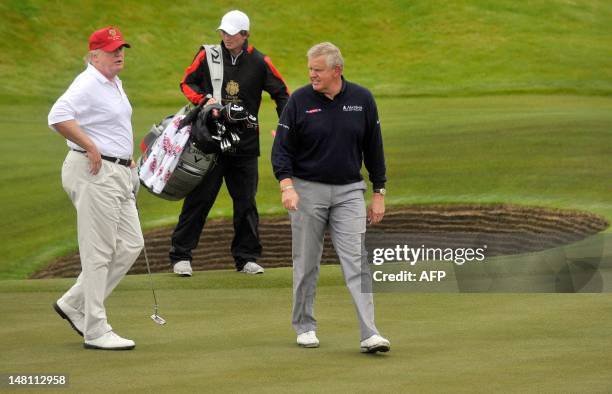 Tycoon Donald Trump plays a round of golf with Scottish golfer Colin Montgomerie as he officially opens his new multi-million pound Trump...
