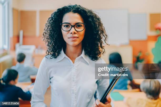 portrait of young teacher in class - black kid standing stock pictures, royalty-free photos & images