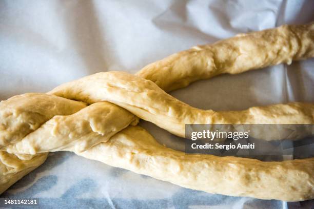 braiding dough to make italian easter bread (pane di pasqua) - braided bread stock pictures, royalty-free photos & images