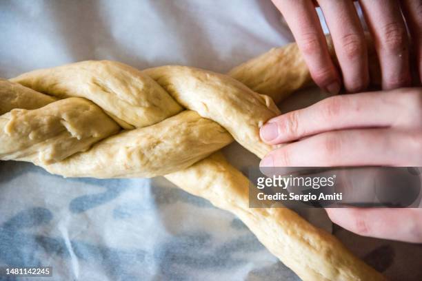 braiding dough to make italian easter bread (pane di pasqua) - braided bread stock pictures, royalty-free photos & images