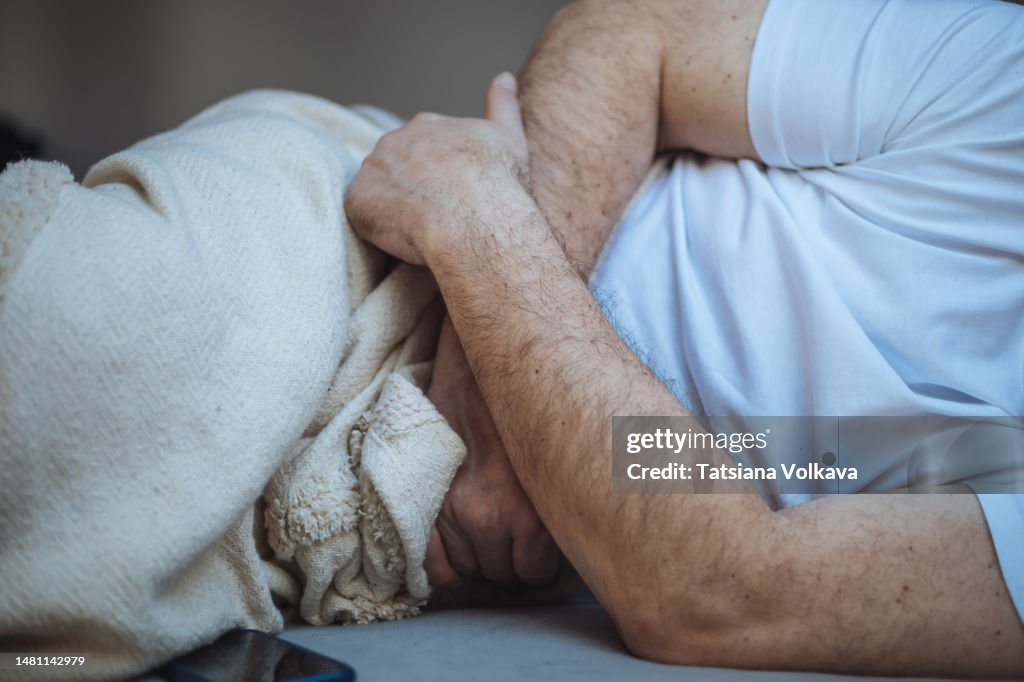 Unrecognizable man stomach pain
