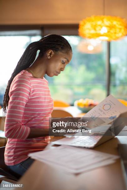 woman working on her finances at home - cutting costs stock pictures, royalty-free photos & images