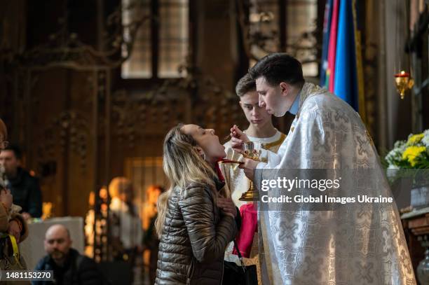 Eastern Rite Santa A priest conducts the rite of Communion during the Palm Sunday's ...