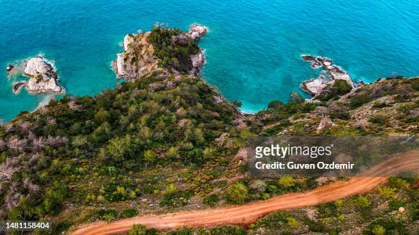 aerial view road trip in a forest, dirt road among trees by the sea, background nature view, aerial road view, aerial sea and road view, walking path by the sea, walking route by the sea, kabak bay road - the lycian way in turkey stock pictures, royalty-free photos & images