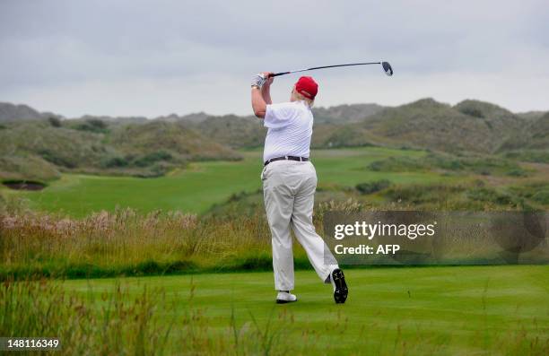 Tycoon Donald Trump plays a stroke as he officially opens his new multi-million pound Trump International Golf Links course in Aberdeenshire,...