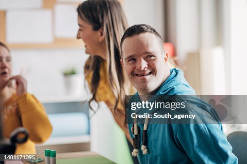 Disability health care art workshop.Down syndrome people doing an art project Disability health care art workshop.Down syndrome people doing an art project