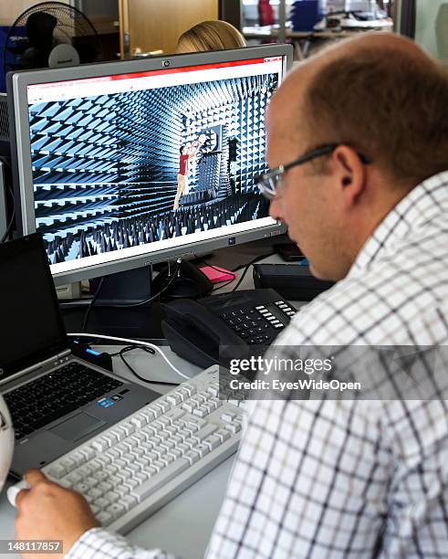 An employee demontrates the GoalRef Technology system on a computer with a magnetic field at Fraunhofer IIS research institute on July 10, 2012 in...