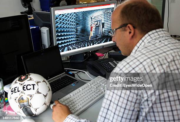 An employee demontrates the GoalRef Technology system on a computer with a magnetic field at Fraunhofer IIS research institute on July 10, 2012 in...