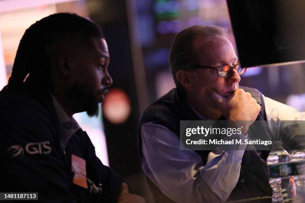 Traders work on the floor of the New York Stock Exchange during morning trading on April 10, 2023 in New York City. The stock market opened low after...