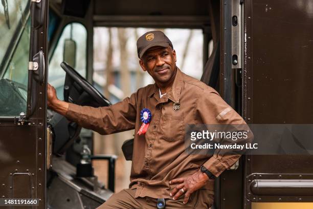 Driver Greg Watkins, of Coram, New York, alongside his delivery truck on his last day of work in Smithtown, New York before retirement, April 6,...