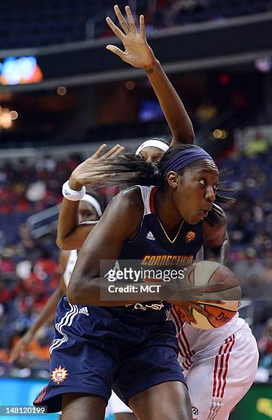 Connecticut Sun center Tina Charles spins to the basket against Washington Mystics guard Natasha Lacy during the first half at the Verizon Center in...