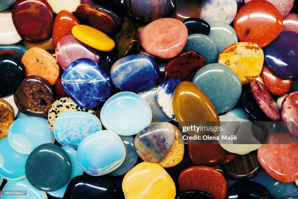 Background made of many different multi colored minerals and crystals in flat lay style