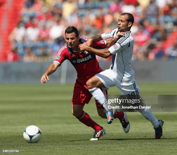 Marco Pappa of the Chicago Fire and Juninho of the Los Angeles Galaxy battle for the ball during an MLS match at Toyota Park on July 8, 2012 in...