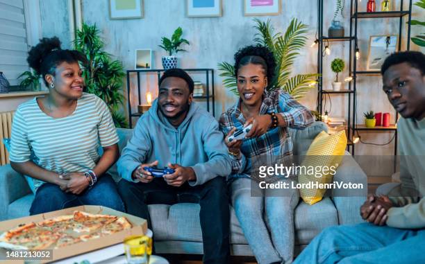 hanging out and playing video games - adrenaline junkie stock pictures, royalty-free photos & images