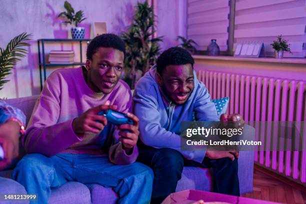 hanging out and playing video games - nintendo stock pictures, royalty-free photos & images