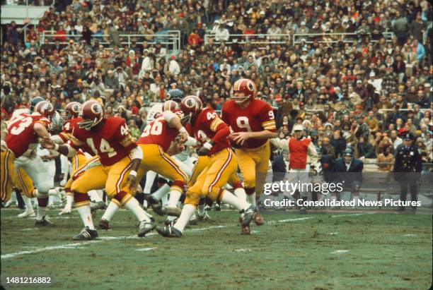 American football player Sonny Jurgensen , quarterback for the Washington Redskins, hold the football during a game against the Chicago Bears at RFK...