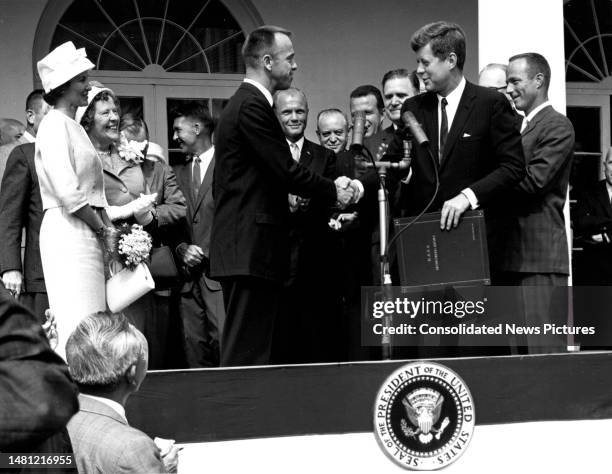 During a reception in the White House Rose Garden, American astronaut Alan B Shepard Jr shakes hands with US President John F Kennedy , Washington...