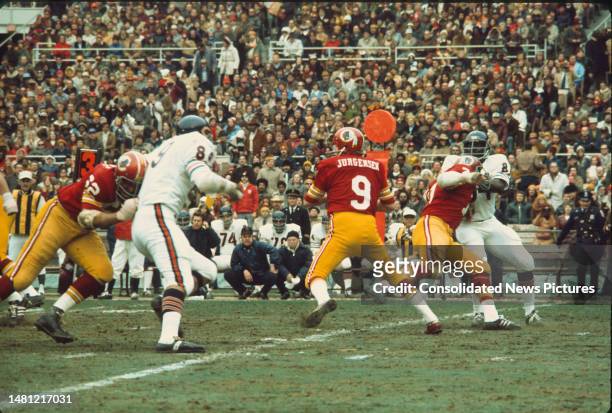 American football player Sonny Jurgensen , quarterback for the Washington Redskins, hold the football during a game against the Chicago Bears at RFK...
