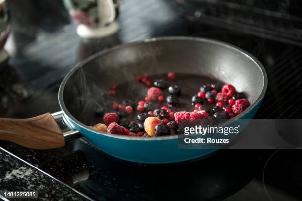 cooking pan with berry fruits - fruit pot stock pictures, royalty-free photos & images