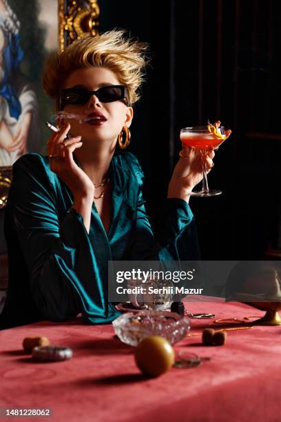 close-up of woman taste cocktails and smoking - stock photo - rubbing alcohol stock-fotos und bilder