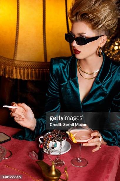 close-up of woman taste cocktails and smoking - stock photo - martini stock pictures, royalty-free photos & images