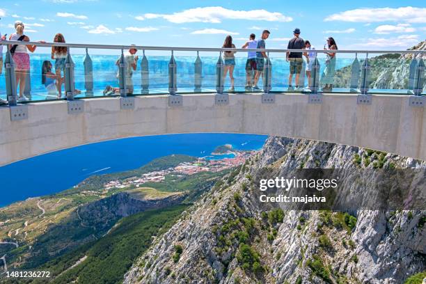 tourist zu fuß und mit blick auf den skywalk biokovo. in der ferne adria und stadt makarska, kroatien - naturpark stock-fotos und bilder