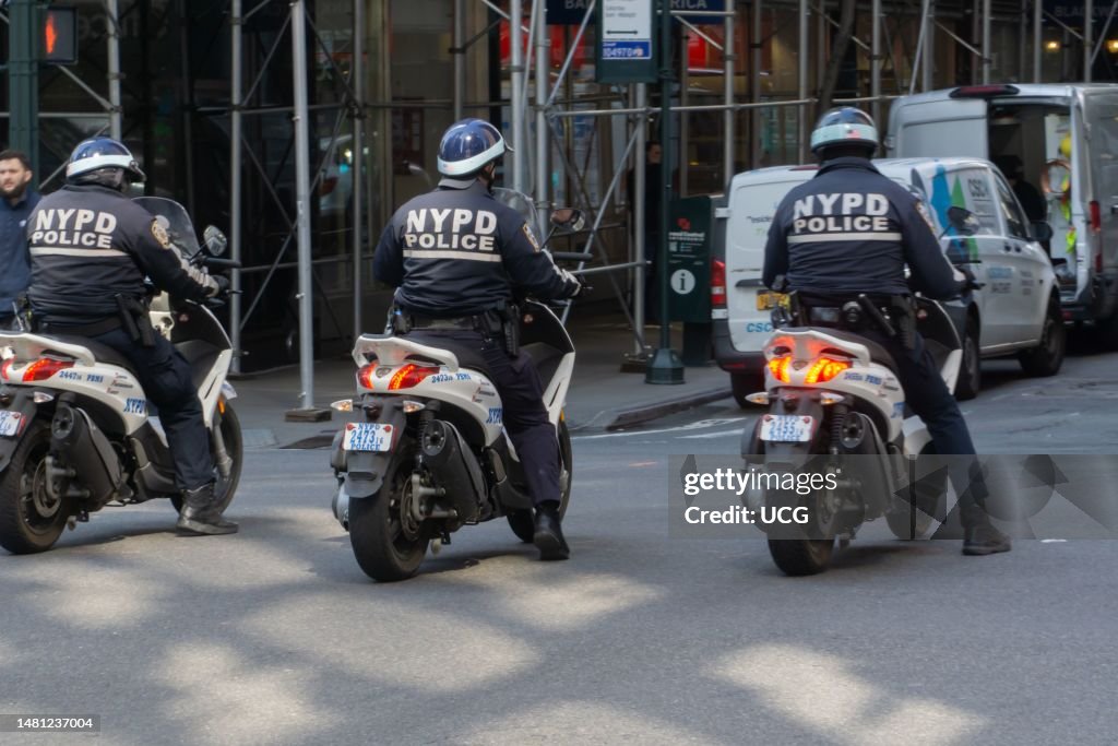 3 NYPD police officers ride their motorcycles at front of climate march