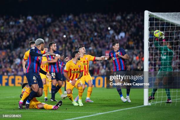 Paulo Gazzaniga of Girona FC makes a save against Ronald Araujo of FC Barcelona during the LaLiga Santander match between FC Barcelona and Girona FC...