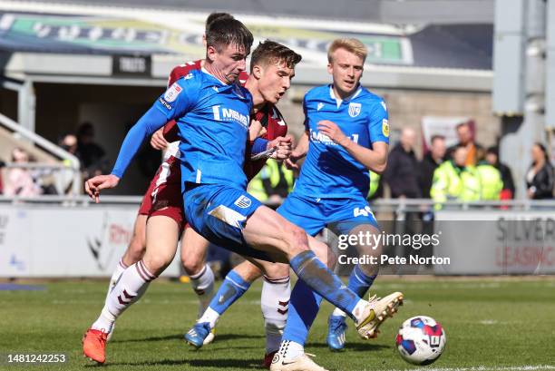 Oli Hawkins of Gillingham plays the ball under pressure from Harvey Lintott of Northampton Town during the Sky Bet League Two between Northampton...