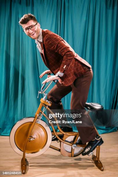 retro man riding vintage exercise bike in broadcast setting - 1970 sport america stock pictures, royalty-free photos & images