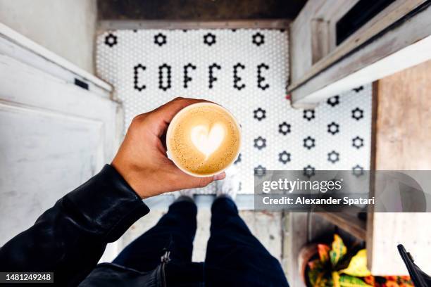 man buying takeaway coffee in a coffee shop, personal perspective view - coffee cup takeaway stock-fotos und bilder