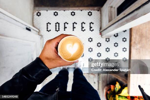 man buying takeaway coffee in a coffee shop, personal perspective view - latte barista stock pictures, royalty-free photos & images