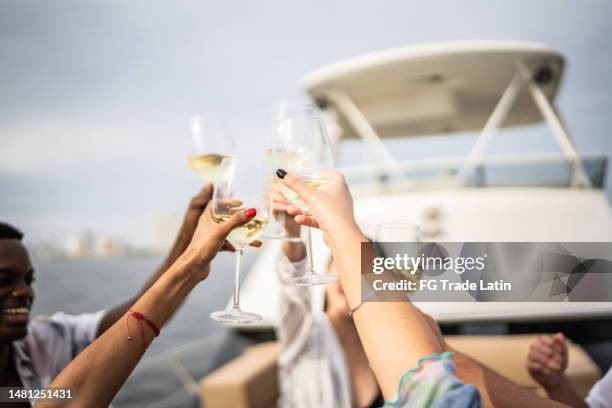 friends making a toast during a yacht party - navio de passageiros imagens e fotografias de stock