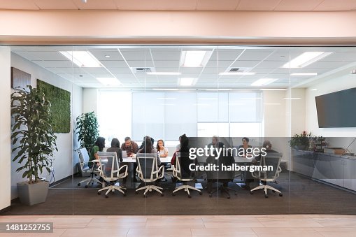Diverse Group Of People Talking To Each Other On a Board Table Diverse Group Of People Talking To Each Other On a Board Table