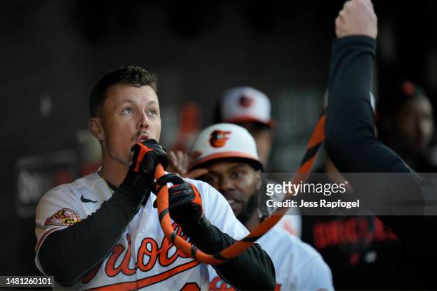 Ryan Mountcastle of the Baltimore Orioles celebrates in the dugout after hitting a home run against the Oakland Athletics in the first inning at...