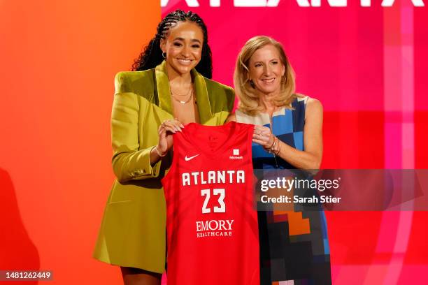 Commissioner Cathy Engelbert and Haley Jones pose for photos after Jones was drafted 6th overall by the Atlanta Dream during the 2023 WNBA Draft at...