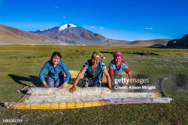 Family hand makes a felt yurt to live in on the tundra lands of Ulgii, Mongolia on August 24, 2018.