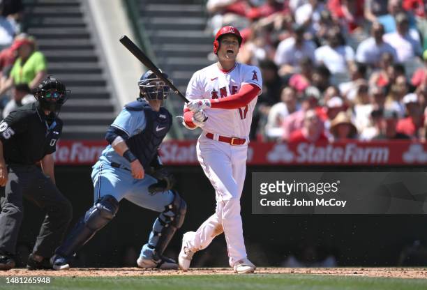 Shohei Ohtani of the Los Angeles Angels shouts a warning as a foul ball heads toward the Toronto Blue Jays dugout at Angel Stadium of Anaheim on...