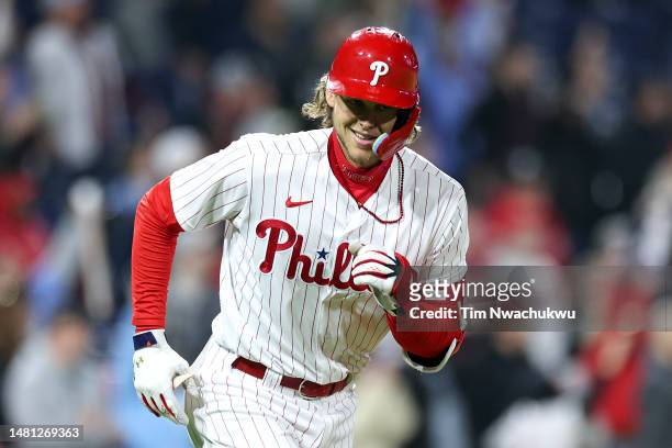 Alec Bohm of the Philadelphia Phillies rounds bases and reacts after hitting a three run home run during the sixth inning against the Miami Marlins...