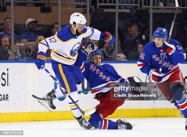 Jordan Greenway of the Buffalo Sabres checks Braden Schneider of the New York Rangers during the second period at Madison Square Garden on April 10,...