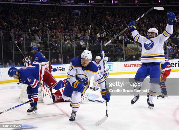 Casey Mittelstadt of the Buffalo Sabres celebrates his third period game-tying goal against the New York Rangers and is joined by Alex Tuch at...