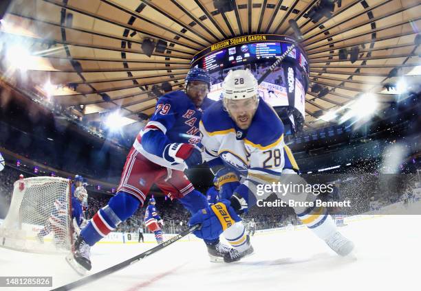 Zemgus Girgensons of the Buffalo Sabres is checked by K'Andre Miller of the New York Rangers during the third period at Madison Square Garden on...