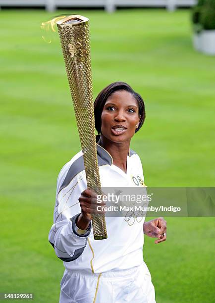 Denise Lewis carries the Olympic torch around the parade ring on day 53 of the London 2012 Olympic Torch Relay at Ascot Racecourse on July 10, 2012...