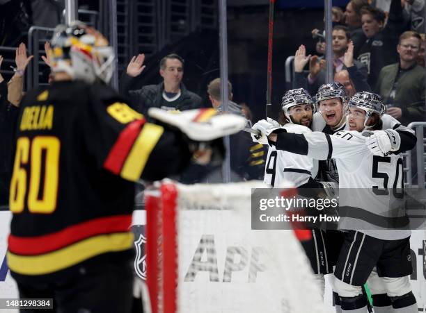 Arthur Kaliyev of the Los Angeles Kings celebrates his goal between Alex Iafallo and Sean Durzi in front of Collin Delia of the Vancouver Canucks, to...