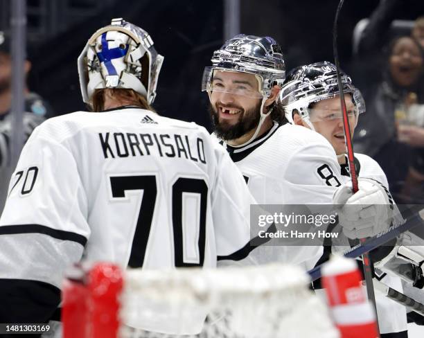 Drew Doughty of the Los Angeles Kings celebrates his empty net goal with Joonas Korpisalo and Mikey Anderson, to take a 3-0 lead over the Vancouver...