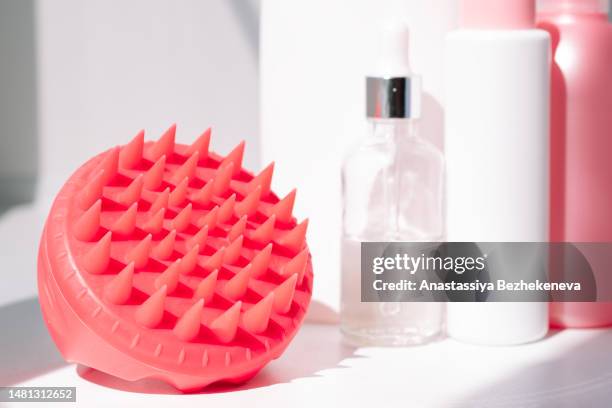 means and massager for the care of the scalp and hair in front of the mirror - human scalp stock pictures, royalty-free photos & images