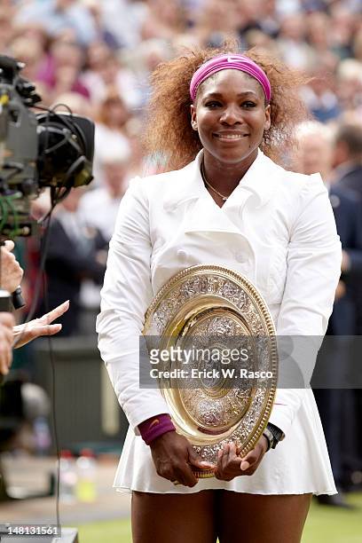 Serena Williams victorious with Rosewater Dish Trophy after winning Women's Final vs Poland Agnieszka Radwanska at All England Club. London, England...